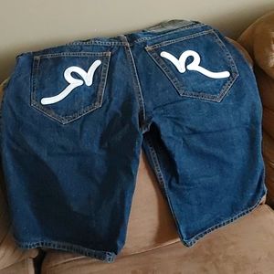 Blue rocawear jean shorts with white stitched logo on back pockets